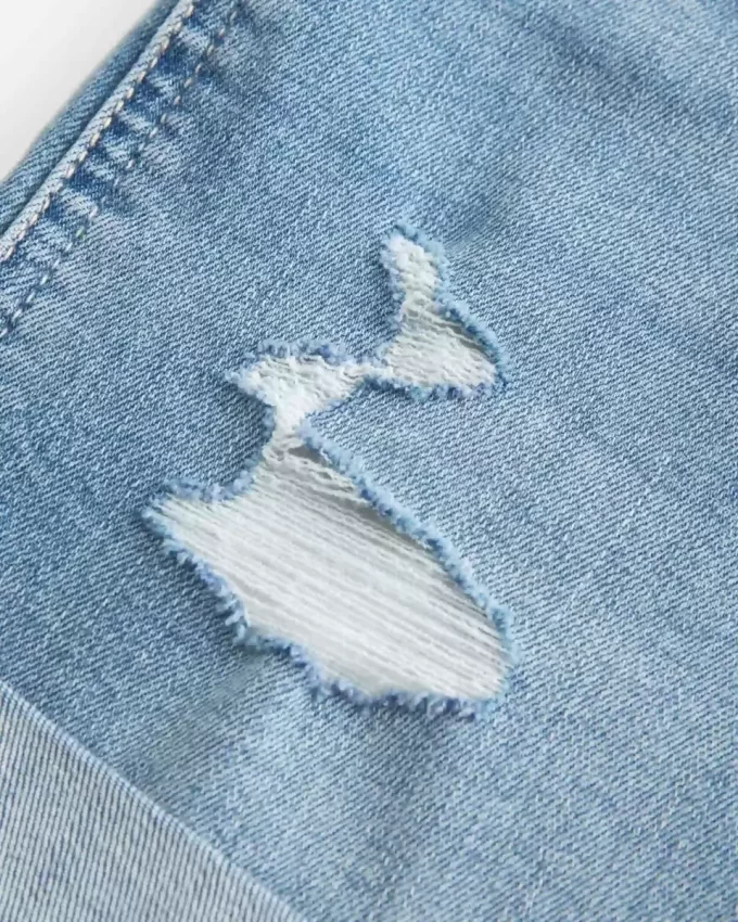 High-Rise Ripped Medium Light Wash Denim Shortie Shorts